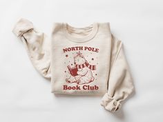 North Pole Book Club Sweatshirt, Book Lover Christmas Shirt, Bookish Christmas Sweater, Bookish Crewneck, Teacher Holiday Gift, Bookworm Tee, Holiday Sweater, Christmas Gift, Xmas Tshirt Sizing and Color Information:  Our shirts are made to order specially for you. For this reason, we don't accept returns or exchanges. To ensure the perfect fit, please refer to our color and size charts before placing your order. If you have any questions, don't hesitate to send us a message to clarify sizing or colors. HOW TO ORDER MULTIPLES: 1. Select your size and color in the drop down menus & add to cart! 2. Then simply go back and repeat for each shirt. If you want to add or change anything on the existing design that we show in the display picture, please contact with us. Product Information: (T-shi Bookish Crewneck, Bookish Christmas, Teacher Holiday Gifts, Club Sweatshirts, Display Picture, Holiday Sweater, North Pole, Christmas Shirt, Size Charts