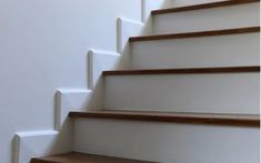 the stairs are painted white and have wooden treads