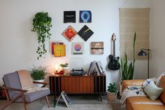 a living room filled with furniture and plants