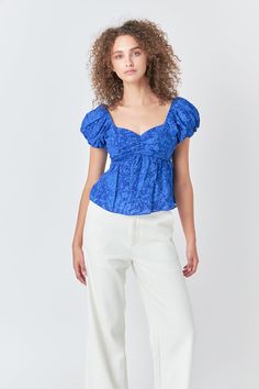 The sweetest way to top off your look. This woven floral top is feminine and sweet with a touch of flirtation. With its short puff sleeves and darling details, this top will have you looking elegant for any occasion. We love the off-shoulder style which gives a peek of skin, while the back tie detail adds just the right touch of intrigue. Woven floral fabrication Sweetheart neckline Short puff sleeves Optional off-shoulder Cut-out back detail Back tie detail Shell: 100% CottonLining: 85% Polyest Flirty Off-shoulder Tops For Brunch, Trendy Puff Sleeve Off-shoulder Top For Spring, Flirty Fitted Short Sleeve Blouse, Chic Off-shoulder Short Sleeve Top For Day Out, Spring Fitted Puff Sleeve Top With Short Sleeves, Fitted Short Sleeve Puff Top For Spring, Elegant Blue Puff Sleeve Top For Spring, Chic Off-shoulder Puff Sleeve Top For Summer, Flirty Puff Sleeve Tops For Spring