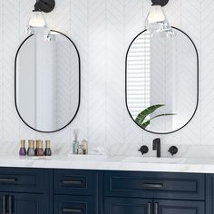 two mirrors on the wall in a bathroom with blue cabinets and marble counter tops, along with a plant