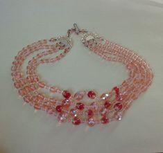 three strand pink beaded necklace with silver clasp