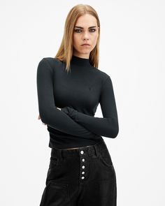 A wardrobe staple. The Rina Long Sleeve T-Shirt is super soft with a little bit of stretch. Shaped to an essential silhouette with a roll neck and long sleeves in a slim fit. We love to keep all the colours on rotation – it's a go-to piece.    This t-shirt is designed to a slim fit Pullover Roll neck Long sleeves Wardrobe staple Allsaints Long Sleeve Tops For Fall, Casual Allsaints Tops For Winter, Allsaints Cotton Tops For Fall, Casual Fitted Turtleneck, Trendy Turtleneck T-shirt For Fall, Allsaints Long Sleeve Tops For Spring, Allsaints Fitted Tops For Spring, Basic Turtleneck Tops For Fall, Allsaints Cotton Long Sleeve Tops