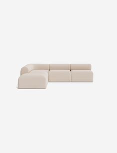 a white sectional couch sitting on top of a white floor