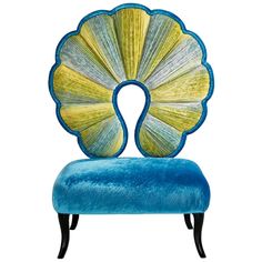 a blue and yellow chair with an intricate shell design on it's backrest