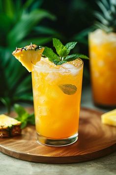 a pineapple and mint cocktail on a wooden tray