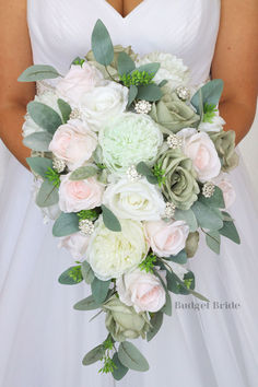 a bridal holding a bouquet of white and pink flowers