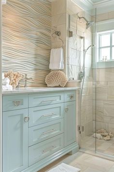 a bathroom with blue cabinets and white towels