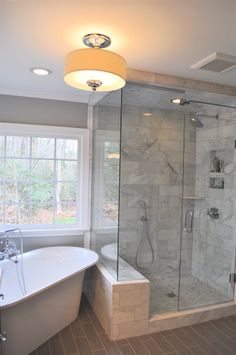 a bathroom with a tub, shower and sink