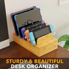 a wooden desk with a computer monitor and game controllers on it