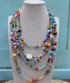 "This showstopping jewelry set is handmade from a variety of high-quality glass beads, including millefiori beads. The necklace has five strands in a true rainbow of colors and parade of shapes and sizes. Includes a matching bracelet and earrings. The bracelet is currently 7.5\", but I would be happy to customize for you." Cheap Multicolor Strand Jewelry, Colorful Multi-strand Czech Glass Beaded Jewelry, Multi-strand Czech Glass Colorful Beads Jewelry, Spiritual Multi-strand Czech Glass Jewelry, Multicolor Czech Glass Jewelry For The Beach, Multicolor Czech Glass Jewelry For Beach, Colorful Multi-strand Czech Glass Beaded Necklaces, Multi-strand Colorful Czech Glass Beaded Necklaces, Multi-strand Czech Glass Necklaces With Colorful Beads