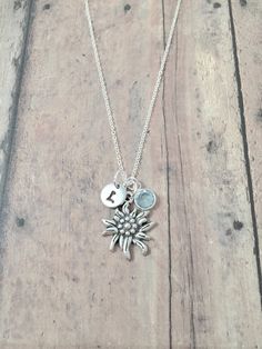 "This listing is for a hand stamped initial necklace featuring a 4/5\" x 3/5\" silver plated edelweiss charm, 1/5\" birthstone pendant, & 3/10\" stainless steel initial pendant. The silver plated chain is 18\" long, but can be made to your desired length- see last photo in listing. Please indicate the chain length you would like in the 'notes to seller' section at checkout. All items are lead & nickel free. Message me with any questions, thank you! Add an initial to any necklace https://www.etsy Edelweiss Necklace, Edelweiss Jewelry, Baby Shower Jewelry, Texas Jewelry, Name Necklace Silver, Wolf Necklace, Jewelry Nature, Equestrian Jewelry, She Wolf