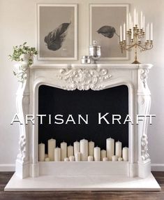 a white fireplace with candles and pictures above it