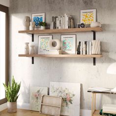 two wooden shelves on the wall above a desk with books and pictures in vases