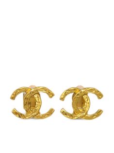 circa 1990-2000 gold plated polished finish signature interlocking CC logo post-back fastening These earrings come as a pair. Condition: GOOD. This previously owned and used item is in good condition with minimal signs of use. This may include fading of material or plating and scratches. Purchasing this item continues its narrative and reduces the environmental impact by avoiding the use of new resources needed to make the product from scratch, such as water, materials and electricity, and avoiding additional manufacturing impact. Learn more about what makes a product Conscious on our Conscious Criteria page Designer Gold Jewelry With Gold-tone Hardware, Designer Gold-tone Logo Plaque Earrings For Formal Occasions, Gold Jewelry With Logo For Anniversary, Gold-tone Logo Plaque Jewelry For Anniversary, Gold Jewelry With Gold-tone Logo Plaque For Anniversary, Luxury Gold Clip-on Earrings With Logo, Classic Yellow Gold Earrings With Logo Plaque, Designer Yellow Gold Jewelry With Logo Lettering, Designer Gold Tarnish Resistant Earrings