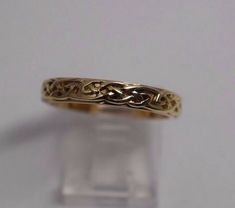 a gold ring with an intricate design on it