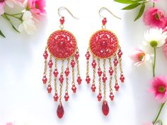 Exquisite and elegant, these red earrings with round-shaped charms on chains resemble dreamcatchers. Crafted from high-quality beads, they captivate with their mysterious allure and refined design. Wear them to add a touch of mystique and style to your look. Dimensions:  Length 10 cm (3.9 inches) Width 3 cm (1.2 inches) Earrings With Chain, Dreamcatcher Earrings, Dream Catcher Earrings, Handmade Beaded Jewelry, Red Earrings, Jewelry Boho, Chain Earrings, Red And Gold, Chandelier Earrings