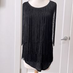 Black T-Shirt Material Sleeveless Top With Layers Of Long Black Fringe. Very Swingy If You Need That Kind Of Energy In Your Life! New With Tags. Fitted Sleeveless Tank Top With Fringe, Fitted Sleeveless Fringe Tank Top, Sleeveless Fringe Tops For Night Out, Sleeveless Fringe Tank Top For Party, Sleeveless Party Tank Top With Fringe, Party Fringe Sleeveless Tank Top, Black Sleeveless Tank Top For Date Night, Party Fringe Tank Top, Black Fringe Top For Night Out