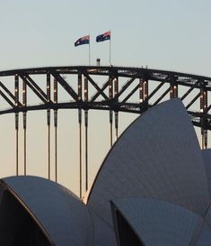 an australian flag flying over the sydney opera house