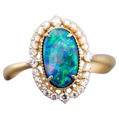 Engagement Ring: Australian Black Opal and Diamond in 18K Yellow Gold Free Domestic USPS First Class Shipping! Free Gift Bag or Box with every order! Opal—the queen of gemstones, is one of the most beautiful gemstones in the world. Every piece of opal is unique in its own ways and patterns. We only use high-quality Natural Opals (NO synthetics or imitations) for our jewelry. ---------------------------------------------------------------------------------------------------- ABOUT THIS PRODUCT Solid 18K Yellow Gold Australian Black Opal, 1.32 ct 24 Diamonds: 0.222 ct Opal Body Tone: N4 Opal Brightness: B4-B3 Opal Size: 10 x 6 mm Ring Size: 7 Opal Color: Stnning green and yellow hues. Occasion: Engagement/Anniversary --------------------------------------------------------------------------- Luxury Black Opal Engagement Ring, Radiant Rings, Radiant Ring, Yellow Hues, Australian Black Opal, Beautiful Gemstones, Opal Color, Toned Body, Engagement Anniversary