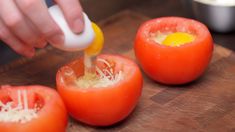 someone is grating cheese on top of the tomatoes to make an appetizer