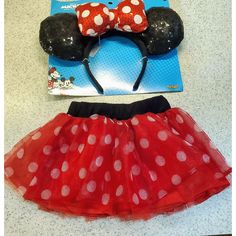 a minnie mouse costume and headband are on display