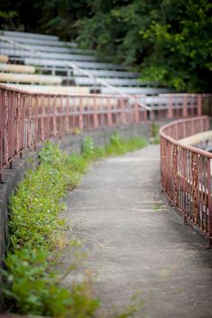 a row of empty bleachers sitting next to each other on a dirt road