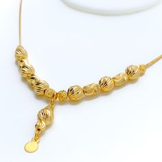 Weighing 10.2 grams, this 21k gold necklace showcases a decorative design with a radiant yellow gold finish, perfect for a dressy occasion. The 17-inch length provides a comfortable fit, while the 1.25-inch drop adds an elegant touch of sophistication. Secured with a lobster lock, this piece combines timeless beauty with intricate craftsmanship, making it an ideal accessory for special events or to elevate everyday style. PRODUCT DETAILS Gold Purity(karat): 21k Gold Weight(grams): 10.2 Item Fini Gold Necklaces With Elegant Pendant Design, Gold Bridal Necklace With Pendant And Elegant Design, Elegant Gold-plated Gold Necklace, Elegant Gold-tone Necklace With Gold Beads, Gold Necklace For Wedding, 16 Inch Length, Elegant 22k Gold Chain Necklace, Elegant 22k Yellow Gold Necklace, Formal Gold Plated Drop Necklace, Formal Gold-plated Drop Necklace