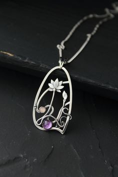 The size H 4 cm x W 3 cm (1 3/4 x 1 inch). Weight - 6g. You can buy it with the chain or without. The most delicate flower of the lotus can make someone very happy. I made this botanical jewelry of sterling silver, amethyst, and peach moonstone. This is a true work of art. It will emphasize your exquisite taste and status, and will also bring a lot of compliments. Lotus flower earrings https://www.etsy.com/listing/676137548/lotus-flower-earrings-sterling-silver?ref=shop_home_active_2&frs=1 O Amethyst Amulet Jewelry For Gifts, Amethyst Amulet Jewelry As Gift, Wire Wrapped Flower Pendant Jewelry Gift, Artistic Silver Wire Wrapped Necklaces, Artistic Silver Wire Wrapped Necklace, Purple Amulet Jewelry As Gift, Purple Amulet Style Jewelry Gift, Purple Amulet Jewelry As A Gift, Art Nouveau Sterling Silver Pendant