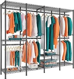 an organized closet with clothes hanging on racks