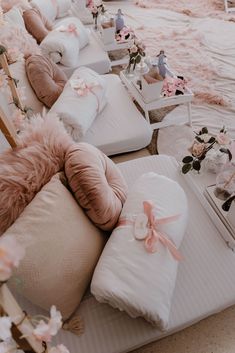 a row of couches with pillows and bows on them