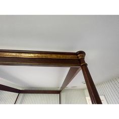 a wooden bed frame with gold paint on it