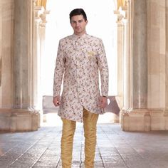 Introducing the Unique Indo Western Sherwani in printed Silk! This magnificent sherwani is made with soft cotton lining and a unique offwhite color silk fabric with delicate print. The matching gold hunter pants complete the look of this regal outfit. Perfect for special occasions, weddings, and festivals, this sherwani is sure to make you stand out from the crowd. Order now and make a grand entrance at your next event! #chirosbyjigyasa #indianclothingusa Bollywood Style Festive Sherwani With Printed Motifs, Festive Bollywood Sherwani With Printed Motifs, Bollywood Sherwani With Printed Motifs For Transitional Season, Traditional Drape Sherwani With Printed Motifs For Festivals, Festive Fitted Sherwani With Printed Motifs, Cream Kurta With Printed Motifs For Wedding, Diwali Bandhgala With Printed Motifs, Wedding Bandhgala With Printed Motifs, Fitted Sherwani With Printed Motifs For Eid