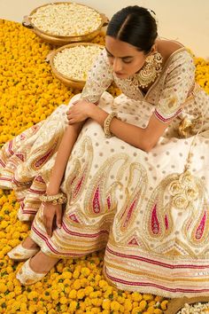 Daisy white pure raw silk lehenga with gotapatti and highlighted with basra moti. Paired with a embroidered blouse and a mustard silk organza dupatta.
Component: 3
Pattern: Embroidered
Type Of Work: Floral, Paisley
Neckline: Leaf
Sleeve Type: Short Sleeves
Fabric: Lehenga and Blouse - Raw Silk; Dupatta - Silk Organza
Color: White
Other Details: 
Gota and bead work
Embroidered dupatta
Tassel detail
Occasion: Wedding,Bride - Aza Fashions Traditional Wedding Dress With Cutdana, Traditional White Gown With Pallu, Traditional White Gown For Festivals, Traditional Saree Dress For Reception, White Gown For Diwali Traditional Ceremonies, Festive Traditional White Gown, White Gown With Pallu For Festivals, Traditional Sharara For Reception And Transitional Season, Traditional White Gown For Transitional Seasons