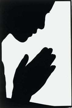 the silhouette of a person praying in front of a white background with black lettering on it