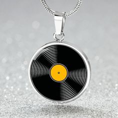 Elevate your style this Halloween with our Yellow Custom Vinyl Records Necklace. This vibrant and unique piece is the perfect gift for musicians and music teachers, celebrating their passion for music. Crafted with care and precision, it boasts an exquisite 18K Gold charm pendant that shines brilliantly, making it an eye-catching accessory for any occasion. Whether you're getting into the Halloween spirit or simply want to show off your musical flair, this necklace is a delightful addition to yo Record Jewelry, Gold Record, Music Teacher Gift, Halloween Music, Rave Accessories, Music Teacher Gifts, Music Jewelry, Glass Coating, Personalized Pendant