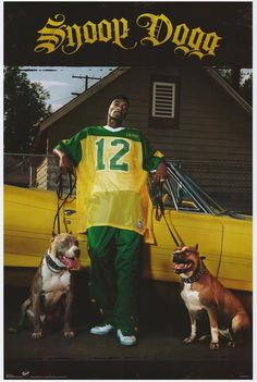 a man standing next to two dogs in front of a yellow car with the word snoop dogg on it