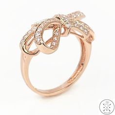 Stunning Rose Gold Ring with Cubic Zirconia This stunning rose gold ring is the perfect way to add a touch of elegance to your look. Featuring round faceted cubic zirconia set in a ribbon style gallery, this ring is sure to turn heads. The cubic zirconia are sparkling and brilliant, and the rose gold band is both stylish and comfortable to wear. The ring is size 5.25 and weighs approximately 2.81 grams. It is in excellent condition, with no visible wear or damage. This ring is a great value for the price. It is made with high-quality materials and is in excellent condition. It is also a timeless piece that you can wear for years to come.    ----SHIPPING INFORMATION---- We ship Monday through Friday, usually within 1 business day of receiving payment. Everything is shipped well-protected so Formal Pink Gold Diamond Ring With Accents, Elegant Diamond Ring For Party, Elegant Party Diamond Ring, Elegant Pink Gold Diamond Ring With Brilliant Cut, Elegant Pink Gold Diamond Ring With Prong Setting, Elegant Sparkling Diamond Rings, Elegant Sparkling Round Cut Diamond Ring, Elegant Round Cut Sparkling Diamond Ring, Elegant Pink Gold Diamond Ring With Accents