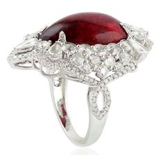 For Sale on 1stDibs - This stunning statement ring has been crafted from 14-karat gold. It is set in 13.65 carats Rubelite and 2.14 carats glimmering diamonds. The ring is a