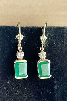 14KY Yellow Gold Emerald & Diamond Earrings Weight 4.6 grams Measures 6.95mm side to side, 30.6mm top to bottom, and 6.94mm front to back Emeralds: approximately 1.3CT each for 2.60CTW Diamonds: approximately 0.10CT each for 0.20CTW, they are I color and Si2 clarity Earrings are in excellent condition See pictures for details and condition Contact us with any questions Classic Emerald Earrings For Formal Occasions, Classic Formal Emerald Earrings, Classic Emerald Drop Diamond Earrings, Classic Gold Emerald Cut Earrings, Classic Emerald Drop Earrings, Classic Emerald Cut Gold Earrings, Classic 14k Gold Diamond Earrings, Hallmarked, Classic Emerald Earrings For Anniversary, Formal Yellow Gold Emerald Cut Diamond Earrings