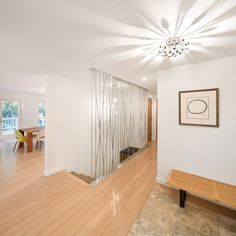 an empty room with wood floors and white walls