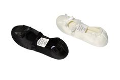 two pairs of black and white shoes with tags on them, one is for children