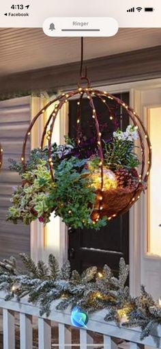 a hanging planter filled with plants on top of a porch