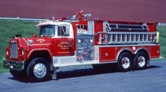 a red fire truck parked in front of a building