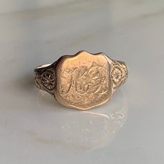 A 9 carat gold signet ring with "HF" engraved on the face.  CONDITION: Wear consistent with age and use. Please see photos for more detail. ASSAYED IN BIRMINGHAM 1938, HALLMARKED 9 CARAT GOLD BAND WIDTH (NARROWEST): 3mm FACE SIZE: 13mm x 12mm RING SIZE: UK: R | US: 8 1/2 WEIGHT: 3.6 grams (UZZ)