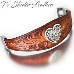 a close up of a wooden bracelet with a heart on it's center piece