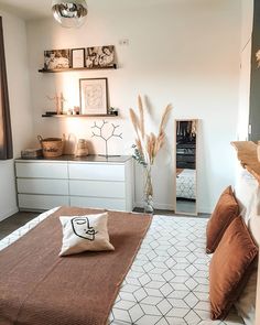 a bed room with a neatly made bed and pillows