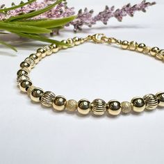 Stunning, elegant and unique! This bracelet is made with a combination of high-quality 14k gold-filled beads with a mix of textures, including 4mm corrugated and 4mm smooth round beads, and 3mm stardust beads. Each is carefully hand-strung on flexible beading wire and finished with a gold-filled clasp, making this simple bracelet a perfect piece to wear alone or for stacking. Also available as a stretch bracelet with no clasp, using durable solid elastic cord.  ● If you prefer a magnetic clasp, Elegant Gold Rosary Bracelet With Faceted Beads, Fine Bracelet, Simple Bracelets, Sarasota Fl, Beading Wire, Crafted Jewelry, Matching Necklaces, Magnetic Clasp, Gold Texture