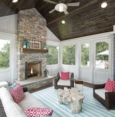 a living room filled with furniture and a fire place in the middle of a room