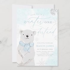 a white polar bear wearing a blue bow tie on it's neck with the words winter